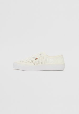 White mesh sneakers with a flat rubber sole, featuring round laces and a small logo accent on the side. Breathable design for comfort.