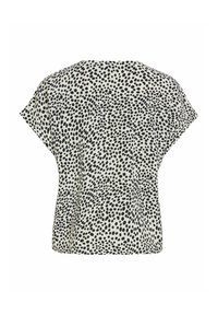 Blouse blanche à manches courtes avec une coupe ample, présentant un motif à pois noirs irréguliers sur toute la surface.