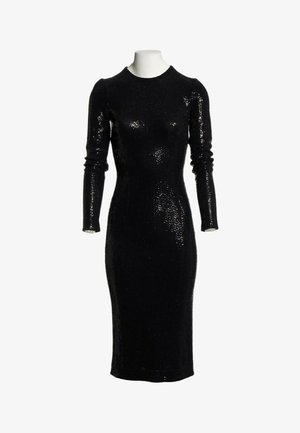 Abito nero aderente con maniche lunghe fino al ginocchio, coperto da piccole paillettes, su un torso di manichino bianco su sfondo bianco.