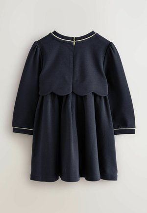 Navyblaues Kleid mit langen Ärmeln, gezacktem Oberteil und gerafftem Rock. Verfügt über einen Reißverschluss und weißen Saum am Ausschnitt und den Ärmeln.