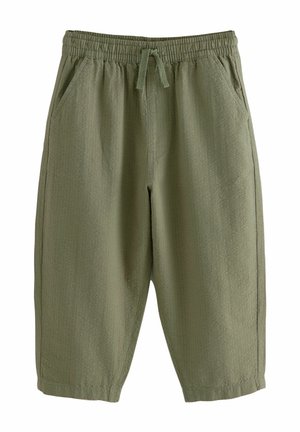 Pantalon en tissu texturé vert olive clair avec ceinture élastique, cordon de serrage, poches latérales et jambes larges coupées au-dessus de la cheville.