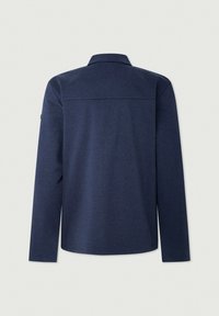 Chemise bleu marine à manches longues avec yoke droit dans le dos et col classique, présentée sur un fond neutre.