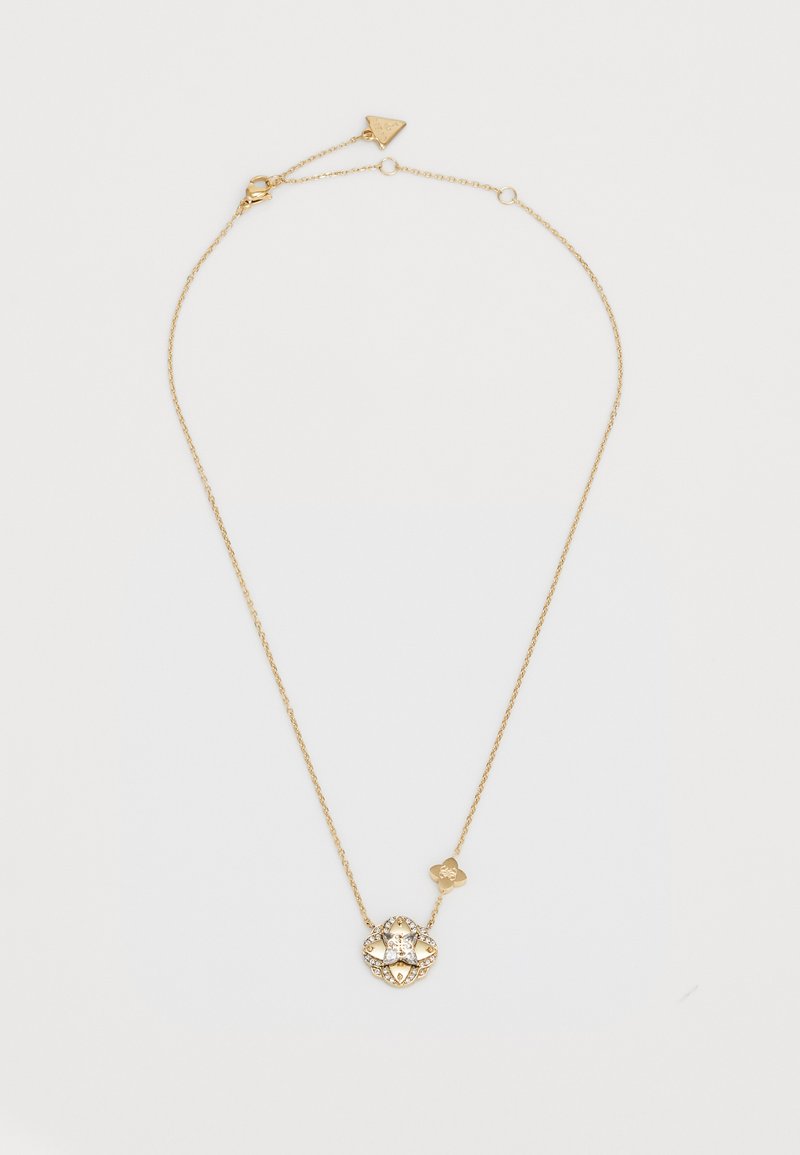 Gold chain necklace featuring a floral pendant with clear gemstones, intricate design, and an adjustable clasp. Elegant and textured detail.