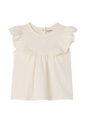 Cream-colored sleeveless baby top with eyelet ruffle detailing around the neckline and a snap button closure at the back.