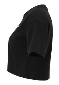 Black cropped t-shirt made of cotton. Short sleeves, round neckline, and no visible patterns. Smooth texture with a clean hemline.