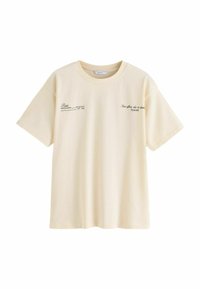 Tricou din bumbac de culoare crem, cu mâneci scurte, având text negru imprimat pe față. Guler rotund simplu și croială lejeră.