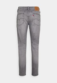 Grijze denim jeans met een slim fit, voorzien van een klassieke vijfzakontwerp, details op de rugvlieg en een leren merkpatch in bruin bij de taille.