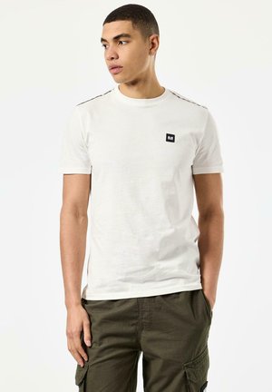 White short-sleeve t-shirt with a black logo patch on the left chest and contrasting black accents on the shoulders.