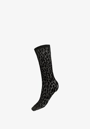 Chaussette noire et grise avec motif léopard s'étendant jusqu'à mi-mollet.