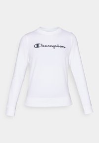 Sweatshirt blanc en coton à manches longues, col rond, avec un logo "Champion" noir sur la poitrine. Possède des poignets et un ourlet côtelés.