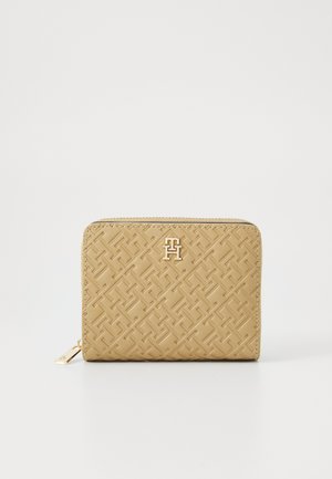 Beige wallet with embossed geometric pattern, zipper closure, and gold logo accent. Smooth texture with rounded corners and stitched edges.