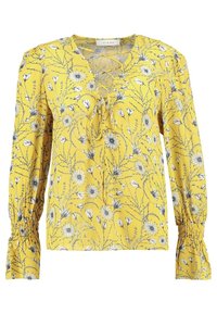 Blouse florale jaune à manches longues, décolletée en V et avec un détail noué à l'avant. Elle présente des poignets froncés et un imprimé botanique sur l'ensemble.