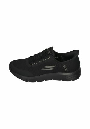 Black athletic shoe with mesh upper, lace-up design, cushioned sole, and textured accents. Features brand logo on the side and heel.