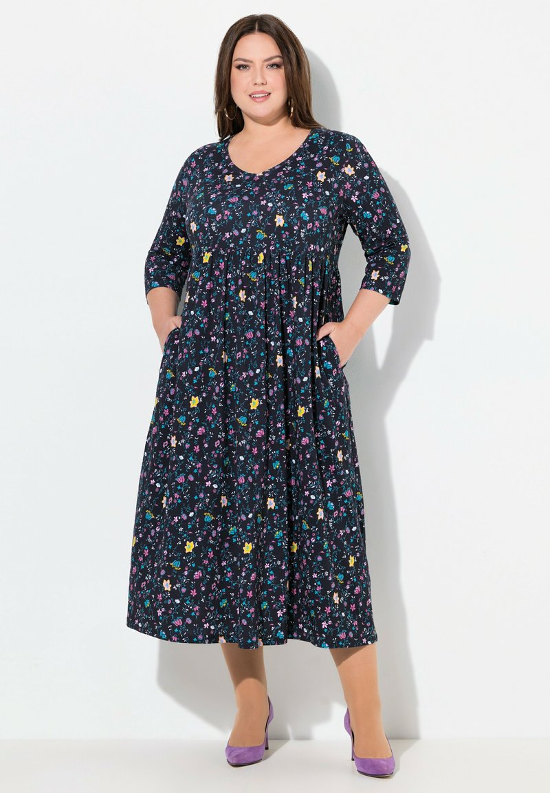 Marineblaues Blumenkleid mit dreiviertel Ärmeln, gerafftem Taillenbund und Seitentaschen. Es verfügt über mehrfarbige Blumenmuster und einen l�ässigen Schnitt.