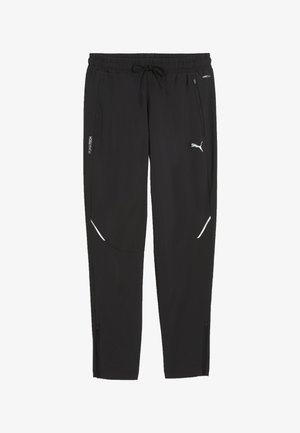 Czarne spodnie sportowe Puma z elastycznym pasem, sznurkiem, kieszeniami zapinanymi na zamek po bokach oraz białym logo Puma na prawej nodze.