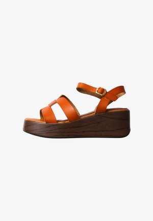Brown wedge sandal with wide orange leather straps and adjustable ankle buckle on white background.