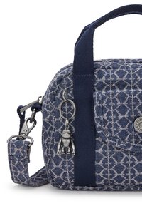 Navy fabric bag with diamond pattern, featuring short handles and a removable strap. Accented with a metal keychain figurine.