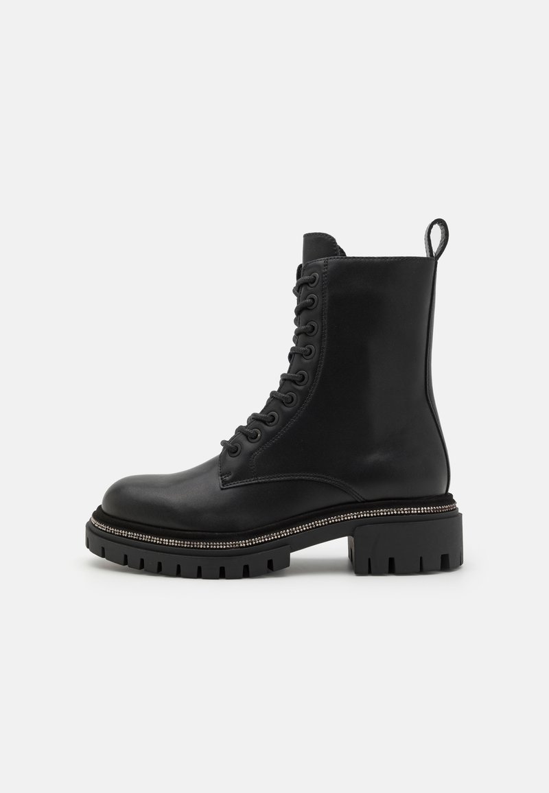 Black leather lace-up ankle boot with a rounded toe, thick chunky sole, and textured decorative stitching around the sole's edge.