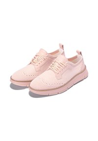 Light pink knit sneakers with a breathable upper, round toe, lace-up closure, and textured accents on the sides and heel. Rubber sole.