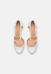 Vita satinballetskor med rund tå, böjda utskärningar och ett tunt ankelsnöre. Mjuka beige innersulor, minimal märkning synlig.