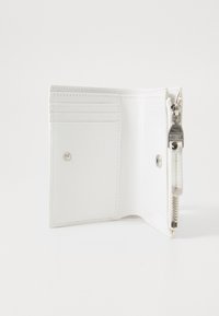 Portefeuille en cuir blanc avec plusieurs emplacements pour cartes, fermeture à pression et tirette en argent. Texture lisse avec un design minimaliste.