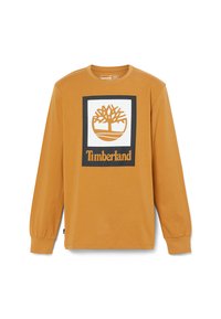 Mustard long-sleeve cotton shirt featuring a central white square with a brown tree logo and "Timberland" text in black below it.