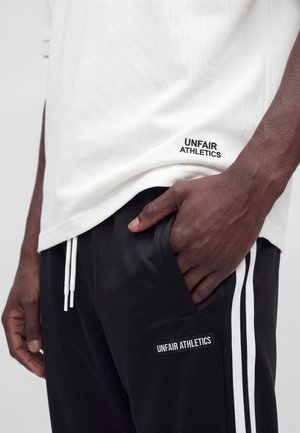 UNFAIR ATHLETICS DMWU EVOLUTION - Joggebukse - black