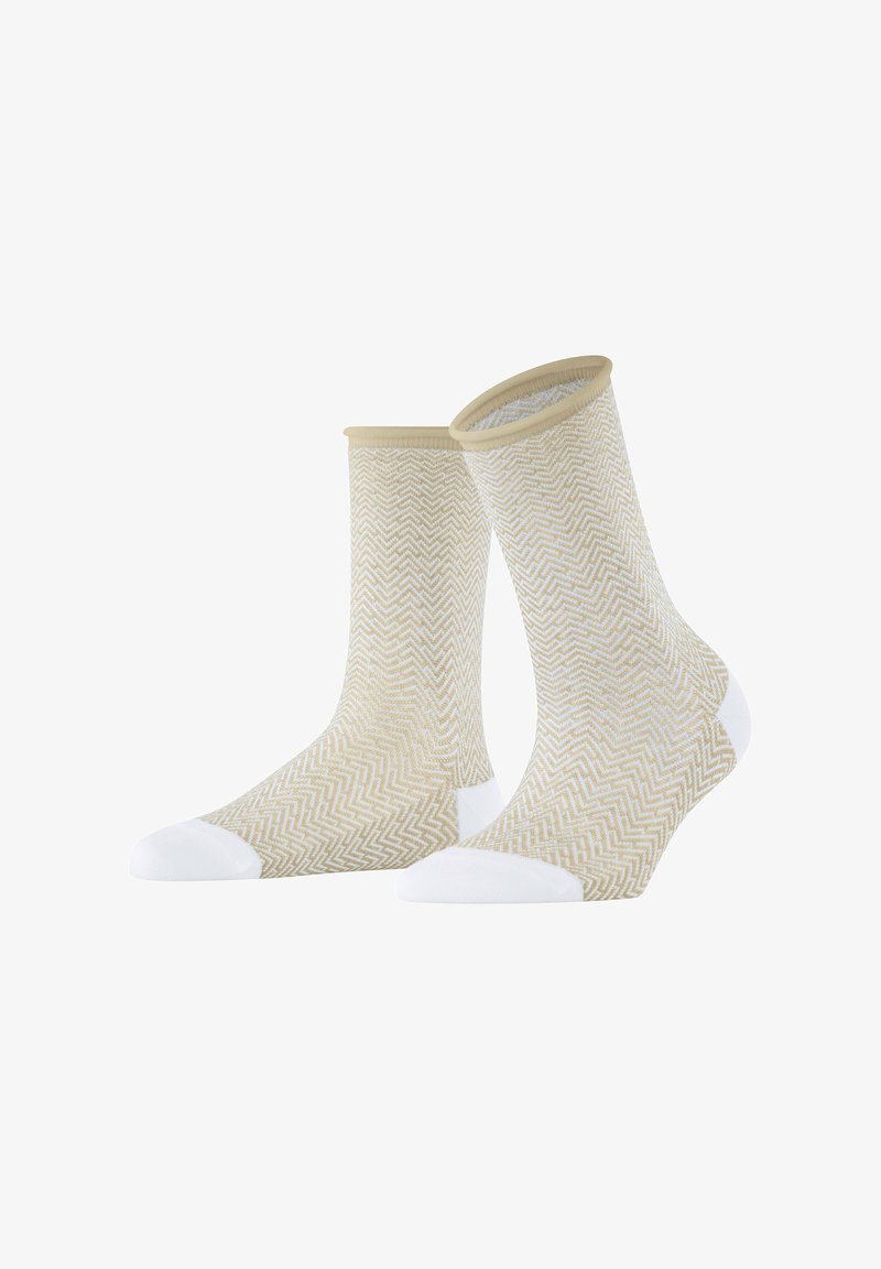 Beige Socken mit einem weißen Zickzackmuster, die eine solide weiße Zehe und einen Bund aufweisen. Das Design ist leicht und strukturiert.