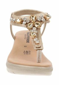 Sandal beige con accenti decorativi di gioielli e cinturino elastico, design open toe, soletta imbottita e suola in gomma. Taglia contrassegnata come 37.