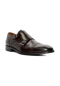 Brown leather double monk strap shoe with smooth finish, rounded toe, and decorative stitching on the cap. Features silver-tone hardware accents.