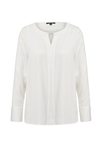Blouse blanche à manches longues en tissu léger, avec un col rond orné d'une fente et des manches à revers. Texture lisse, design minimaliste.