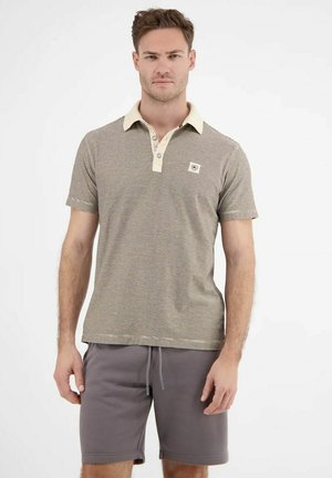 Gestreiftes Poloshirt in Braun und Creme mit einem beigen Kragen, ausgestattet mit einem kleinen Logo-Patch und kurzen Ärmeln, kombiniert mit grauen Shorts.