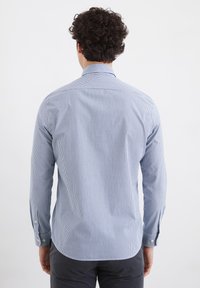 Light blue and white striped button-down shirt with long sleeves, soft texture, and single-button cuffs. Features a classic collar.