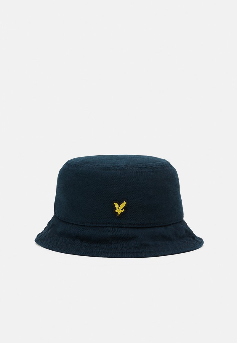 Navy blue bucket hat made of soft fabric, featuring a round crown and a wide, flexible brim. Includes a small yellow embroidered logo.