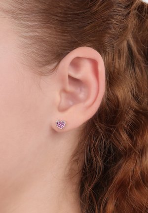 Herzförmige Ohrstecker aus Silber mit einer pinkfarbenen Edelstein-Inlay, die eine glatte Oberfläche und kleine Größe aufweisen und am Ohr getragen werden.