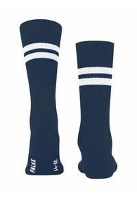 Un paio di calze blu navy al ginocchio con due strisce bianche vicino alla parte superiore, nome del marchio e taglia stampati in bianco nella zona del piede.