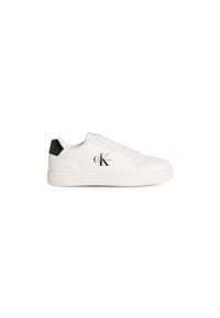 White sneakers with smooth leather upper, black accent at heel, flat rubber sole, and logo detailing on the side. Laced closure design.