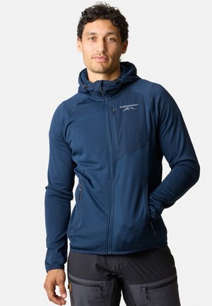 Marineblaue Reißverschlussjacke mit Kapuze, aus strukturiertem Stoff, mit elastischen Bündchen und einer Reißverschluss-Brusttasche. Logo auf der linken Vorderseite.