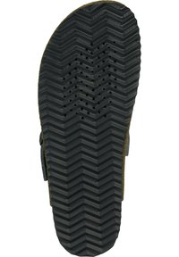 Sole in gomma nera con un motivo a zigzag, caratterizzata da fori di drenaggio circolari e accenti in suede beige sui lati. Design piatto e ampio.