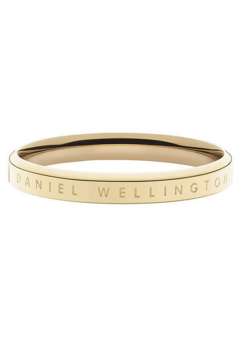Kultaiset sävytetyt rannekorut, joissa on sileä pinta. Korun reunoilla on kaiverrettu "DANIEL WELLINGTON" -teksti. Pyöreä muoto, minimalistinen muotoilu.