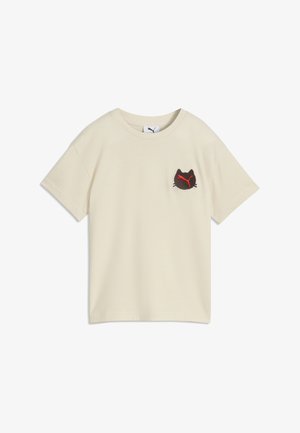 Beżowy t-shirt z krótkim rękawem, z małą naszywką z czarnego kota i czerwonym logo pumy na lewej piersi, pokazany na jednolitym tle.