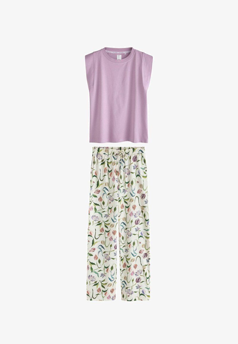 Haut lilas sans manches associé à un pantalon blanc ample avec un motif floral coloré et une taille élastique avec cordon de serrage.