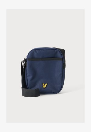 Kleine navyblauwe schoudertas met zwarte verstelbare band en geel geborduurd vogellogo op het voorvak.