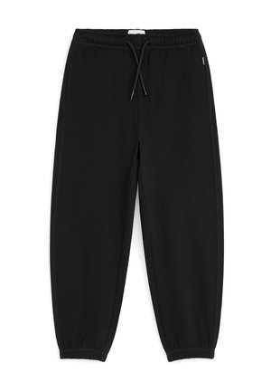 Pantalon de survêtement noir avec taille élastique, cordon, poches latérales et poignets élastiques aux chevilles.