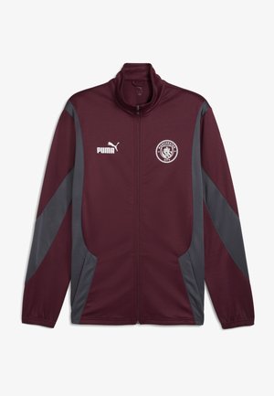 Burgundi sportlik zipp-sjope hallide külgpaneelidega, kõrge kraega, Puma logo ja Manchester City embleem vasakul rinnaosal. Sile kangas.