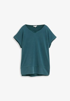 Blouse à manches courtes couleur sarcelle avec un col rond et un large détail d'ourlet, présentée sur un fond blanc.