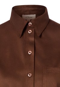 Brown collared shirt with four buttons down the front and a visible chest pocket on a plain background.