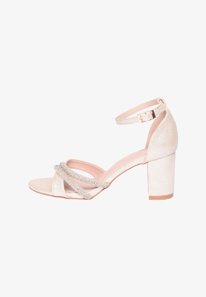 Sandali beige con tacco a blocco e cinturino alla caviglia, dotati di cinturini incrociati ornati da strass, realizzati in un tessuto testurizzato.