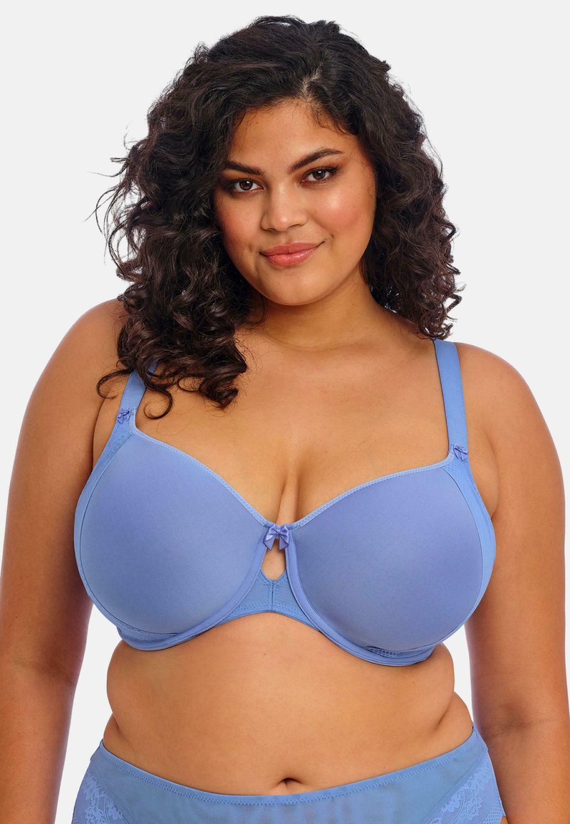 Langaton rintaliivi vaaleansinisestä kankaasta, jossa on kupin yksityiskohtia, pieniä nauhahäntiä keskellä ja säädettävät olkahihnat tukevan istuvuuden varmistamiseksi.