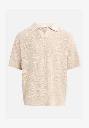 Polo a maniche corte lavorata a maglia color beige con collo aperto e motivo verticale a rilievo.